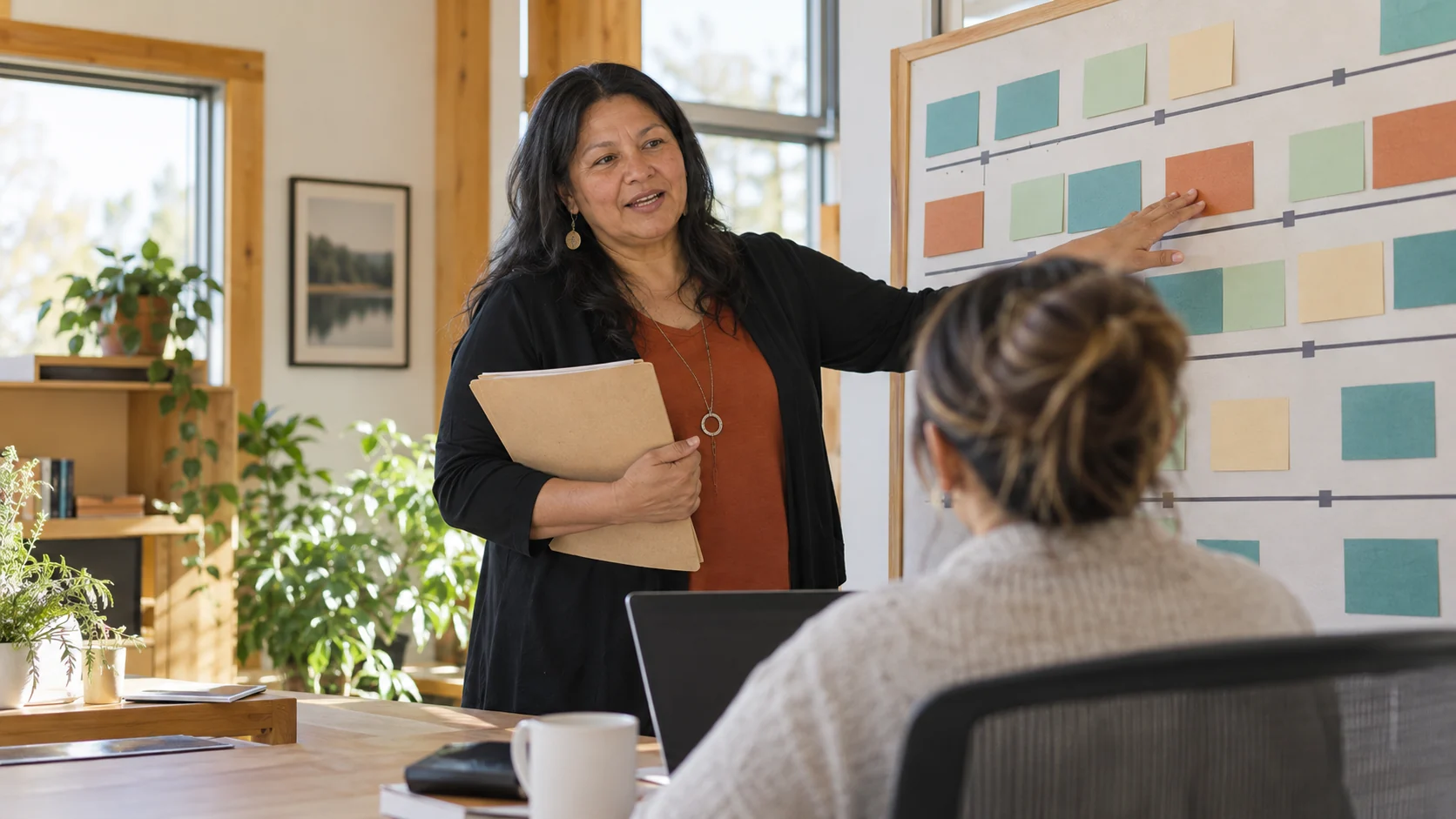 Fictional project coordinator discussing milestones beside a planning board